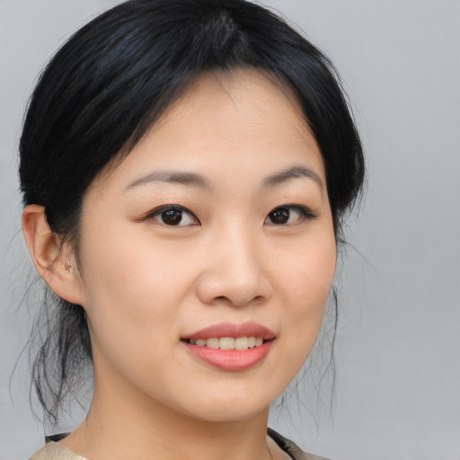Joyful asian young-adult female with medium  black hair and brown eyes