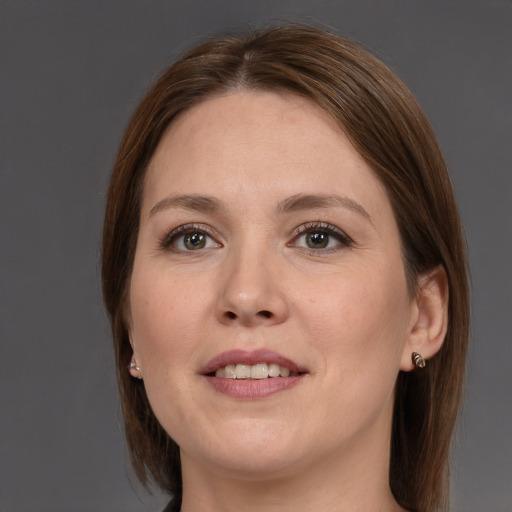 Joyful white young-adult female with medium  brown hair and grey eyes