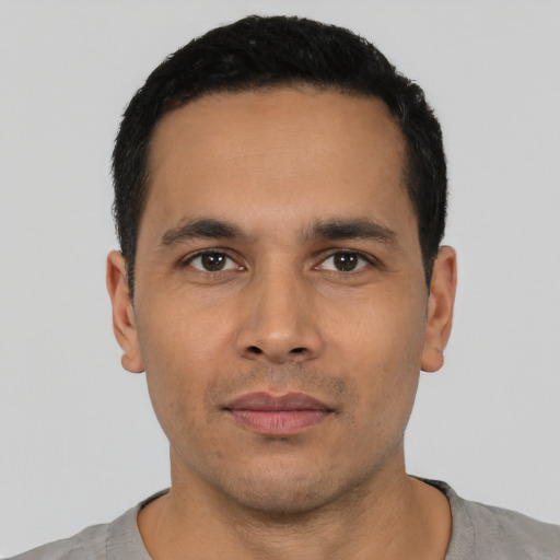 Neutral latino young-adult male with short  black hair and brown eyes