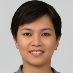 Joyful asian young-adult female with short  brown hair and brown eyes