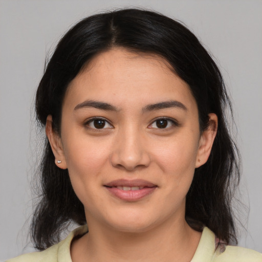 Joyful latino young-adult female with medium  brown hair and brown eyes