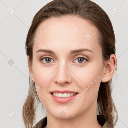 Joyful white young-adult female with long  brown hair and grey eyes