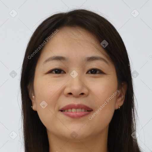 Joyful asian young-adult female with long  brown hair and brown eyes