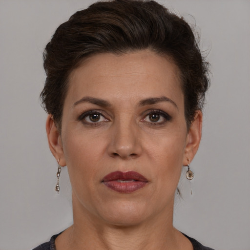 Joyful white adult female with short  brown hair and brown eyes