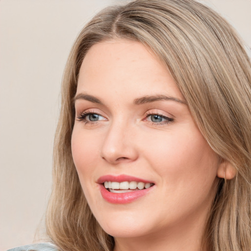 Joyful white young-adult female with long  brown hair and grey eyes