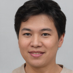 Joyful asian young-adult male with short  brown hair and brown eyes