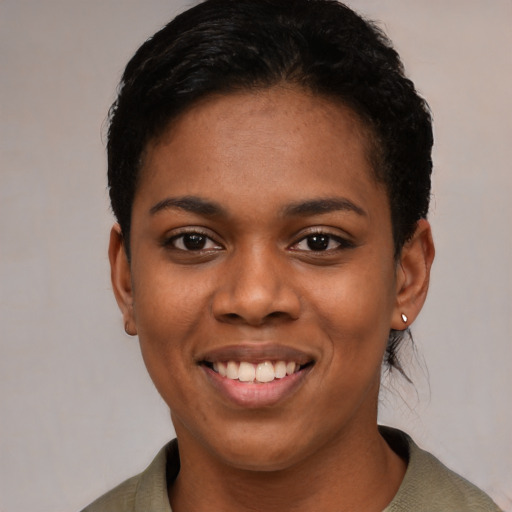 Joyful black young-adult female with short  black hair and brown eyes