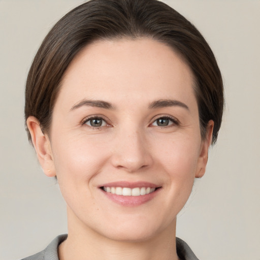 Joyful white young-adult female with short  brown hair and brown eyes