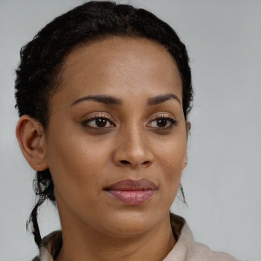 Joyful black young-adult female with short  brown hair and brown eyes