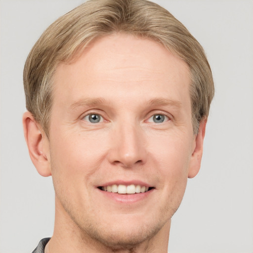 Joyful white adult male with short  brown hair and grey eyes