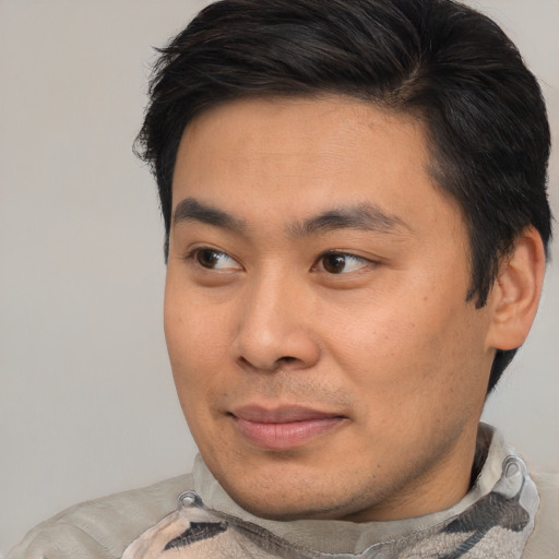 Joyful asian young-adult male with short  brown hair and brown eyes