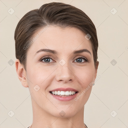 Joyful white young-adult female with short  brown hair and grey eyes