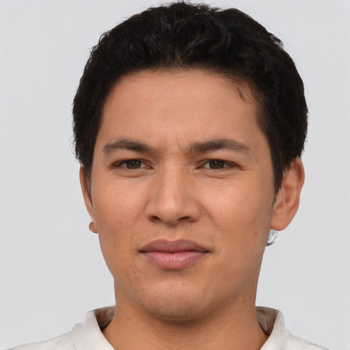 Joyful latino young-adult male with short  brown hair and brown eyes