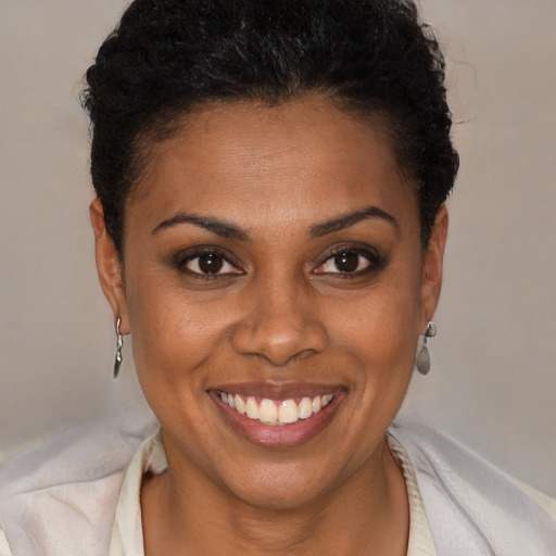 Joyful black young-adult female with short  brown hair and brown eyes