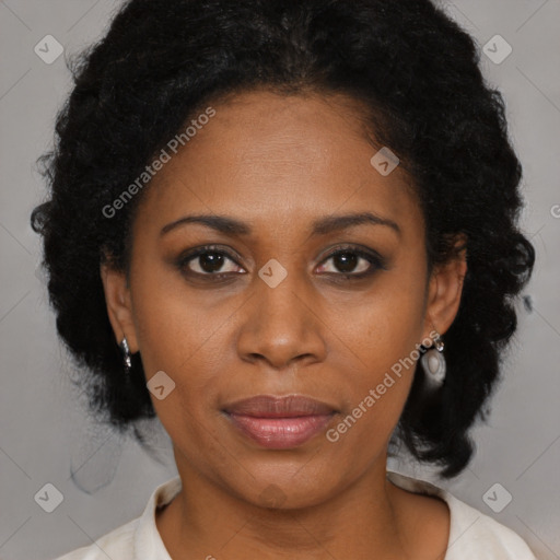 Joyful black adult female with medium  brown hair and brown eyes