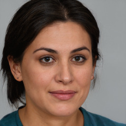 Joyful white adult female with medium  brown hair and brown eyes