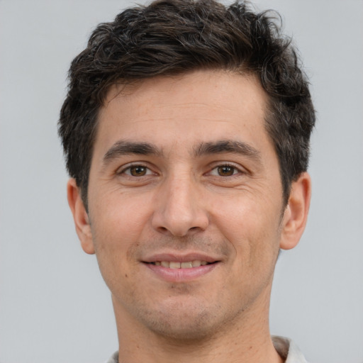 Joyful white adult male with short  brown hair and brown eyes