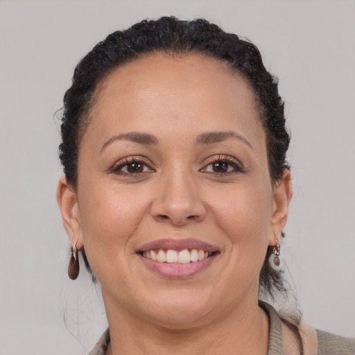 Joyful black adult female with short  brown hair and brown eyes