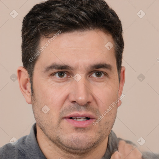 Joyful white adult male with short  brown hair and brown eyes