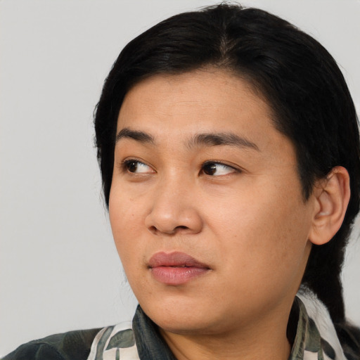 Joyful asian young-adult female with medium  black hair and brown eyes