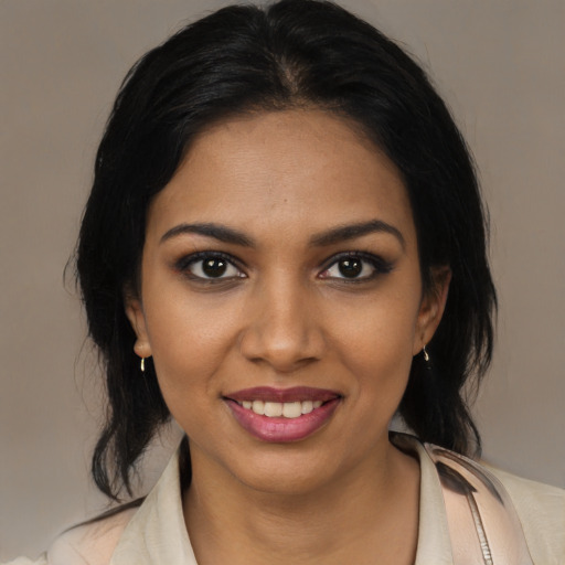 Joyful black young-adult female with medium  black hair and brown eyes