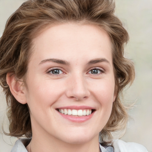 Joyful white young-adult female with medium  brown hair and green eyes