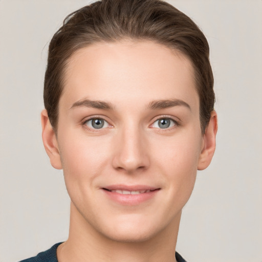 Joyful white young-adult female with short  brown hair and grey eyes