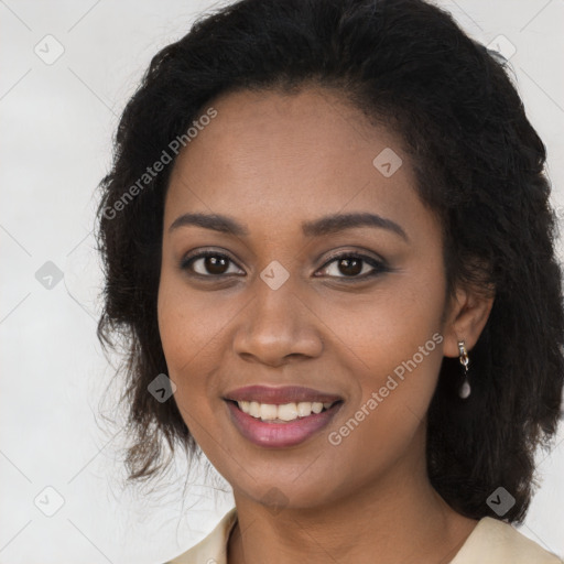 Joyful black young-adult female with long  brown hair and brown eyes