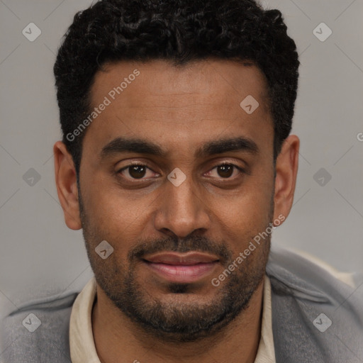 Joyful black young-adult male with short  black hair and brown eyes