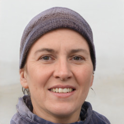 Joyful white adult female with short  brown hair and grey eyes