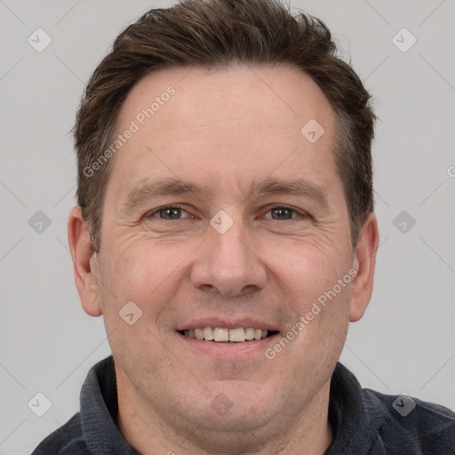 Joyful white adult male with short  brown hair and grey eyes