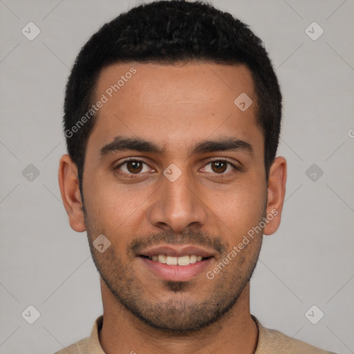 Joyful latino young-adult male with short  brown hair and brown eyes
