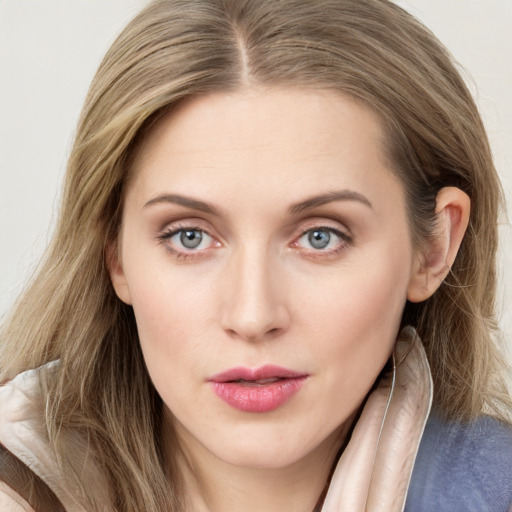 Joyful white young-adult female with long  brown hair and blue eyes