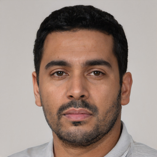 Neutral latino young-adult male with short  black hair and brown eyes