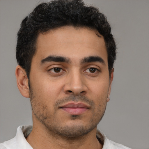 Neutral latino young-adult male with short  brown hair and brown eyes