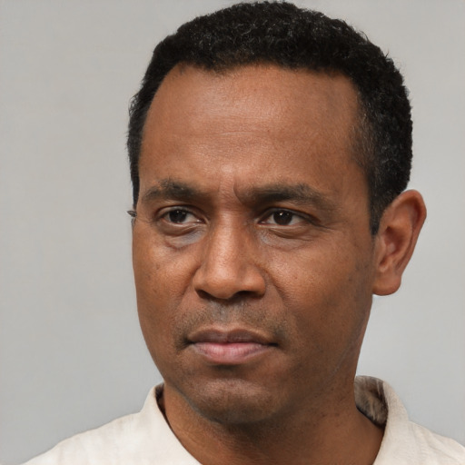 Neutral latino adult male with short  black hair and brown eyes