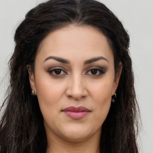Joyful latino young-adult female with long  brown hair and brown eyes