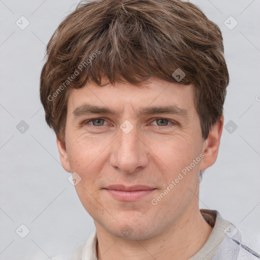 Joyful white adult male with short  brown hair and grey eyes