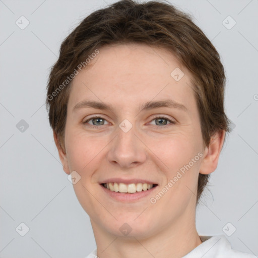 Joyful white young-adult female with short  brown hair and grey eyes