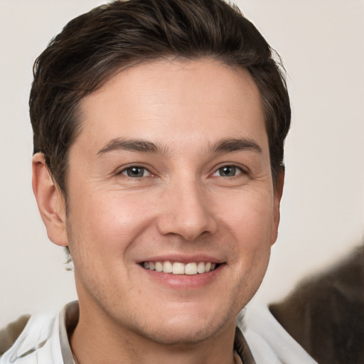 Joyful white young-adult male with short  brown hair and brown eyes