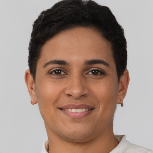 Joyful latino young-adult female with short  brown hair and brown eyes