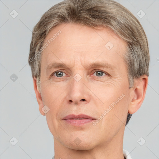 Joyful white adult male with short  brown hair and grey eyes