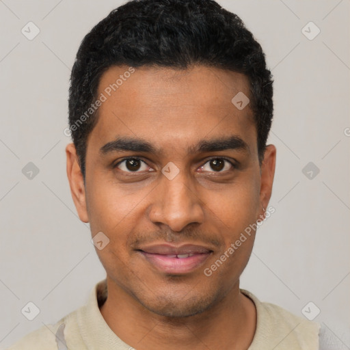 Joyful black young-adult male with short  black hair and brown eyes