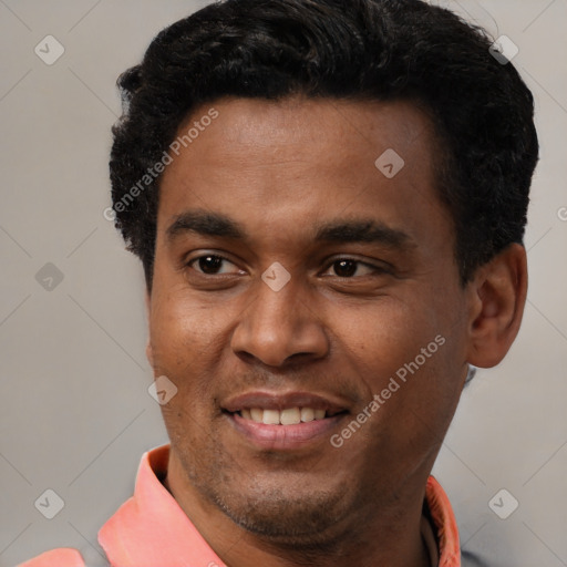 Joyful latino young-adult male with short  black hair and brown eyes