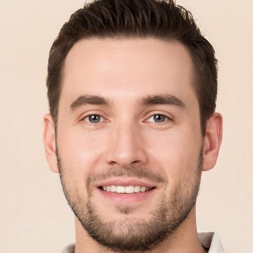 Joyful white young-adult male with short  brown hair and brown eyes