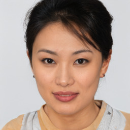 Joyful asian young-adult female with medium  brown hair and brown eyes