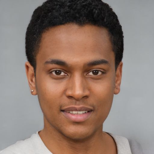 Joyful latino young-adult male with short  brown hair and brown eyes