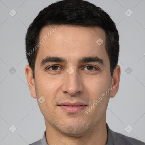 Joyful white young-adult male with short  black hair and brown eyes