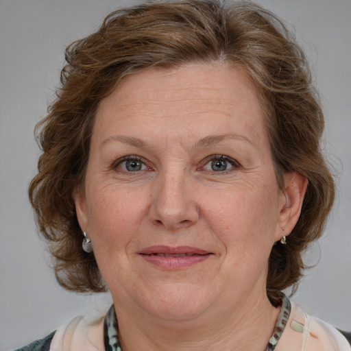 Joyful white adult female with medium  brown hair and blue eyes