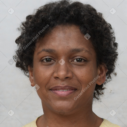 Joyful black adult female with short  brown hair and brown eyes